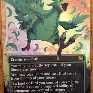 May include: A trading card featuring a green bird-like creature, labeled "Traveling Chocobo." The card has a green and gold color scheme, with the creature in mid-flight. Text at the bottom describes the card's abilities. The card is marked 3/2.