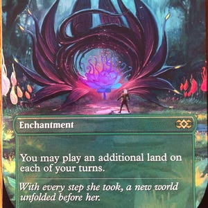 May include: A Magic: The Gathering card titled "Exploration." The card features a fantasy illustration of a large, dark purple flower with a glowing center. The text on the card reads "Enchantment" and includes game instructions.