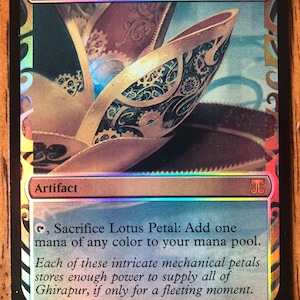 May include: A holographic Magic: The Gathering trading card titled Lotus Petal. The card features a metallic, mechanical lotus flower illustration, a zero mana cost symbol, and text describing the artifact's ability to add one mana of any colour.