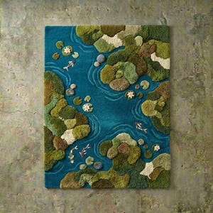 May include: A rectangular rug with a pond design. The rug features a teal blue background with a textured pattern of green and brown islands, white lily pads, and koi fish. The rug is a decorative floor covering.