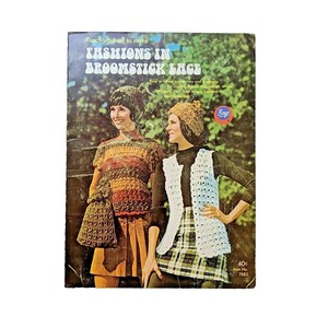 May include: Vintage book cover titled "Fashions in Broomstick Lace" featuring two women modeling crocheted outfits. The outfits include a colorful top, skirt, hat, and purse, and a white vest over a plaid skirt. The cover has a green and brown background.