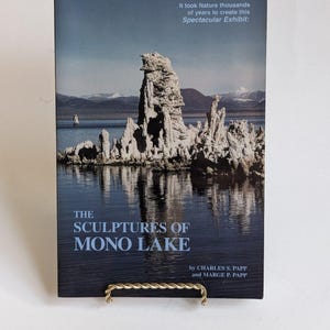 May include: A book titled "The Sculptures of Mono Lake" with a scenic image of the lake and rock formations. The cover text reads "It took Nature thousands of years to create this Spectacular Exhibit:" and the authors are Charles S. Papp and Marge P. Papp.