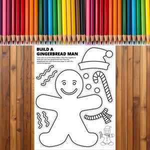 May include: A coloring page with a gingerbread man outline, candy cane, and Santa hat, with the text "BUILD A GINGERBREAD MAN". A row of colorful pencils is at the top, and the background is a wooden surface.