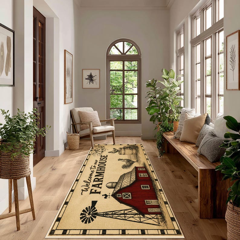 May include: A rectangular runner rug featuring a cream-colored background with a black and red graphic print of a barn, a windmill, and a rooster. The text "Welcome to our FARMHOUSE" is printed in black script and block lettering on the rug.