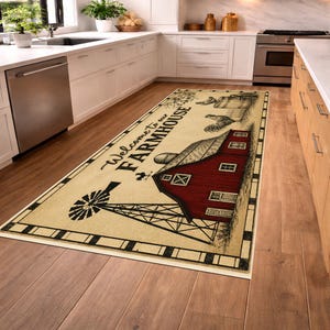May include: A rectangular kitchen runner rug featuring a cream-colored background with a red barn, a black windmill, and a rooster illustration. The text Welcome to our FARMHOUSE is printed in black script and block lettering, framed by a black border.