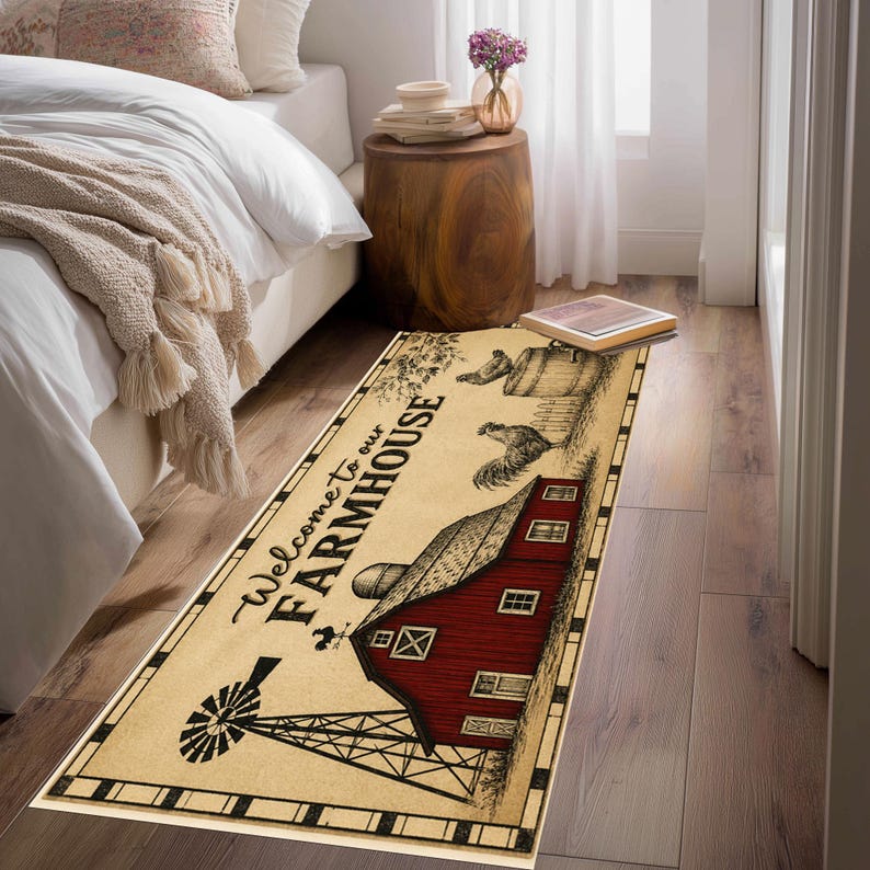 May include: A rectangular area rug featuring a cream-colored background with a black border. The design includes a red barn, a black windmill, a rooster, and the text Welcome to our FARMHOUSE in black script and block lettering.