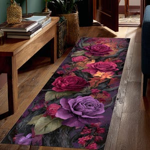 May include: A floral runner rug featuring a vibrant design of large roses in shades of purple, pink, and red. The rug has a dark background with stylized branches and leaves, creating a dramatic and artistic look. The rug is rectangular.
