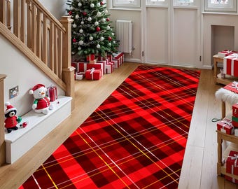 May include: A long, rectangular red and black plaid runner rug with gold accent lines. The rug is placed on a wooden floor, leading towards a Christmas tree and presents. The scene evokes a festive holiday atmosphere.