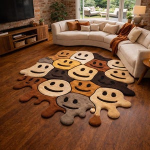 May include: A colorful rug with a pattern of smiling faces in various shades of brown, tan, and yellow. The rug is placed on a hardwood floor in a living room setting, with a white sofa and brick wall in the background.