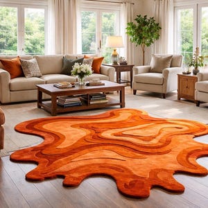 May include: A living room featuring an abstract orange rug with a wavy design. The room includes a beige sofa, two armchairs, and a wooden coffee table. The room is well-lit with natural light from large windows.