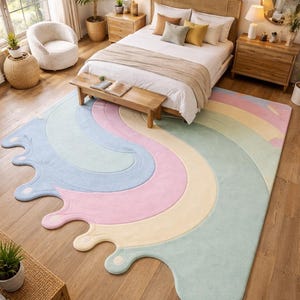 May include: A pastel rainbow-shaped rug with a wavy design in a bedroom setting. The rug features soft colors like light blue, pink, yellow, and green. The rug is placed on a wooden floor, adding a touch of whimsy to the room's decor.