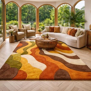 May include: A living room with a large, colorful rug featuring a wavy pattern in shades of brown, orange, yellow, green, and white. The room includes a curved white sofa, wicker chairs, and a wooden coffee table. Large windows offer a view of the outdoors.