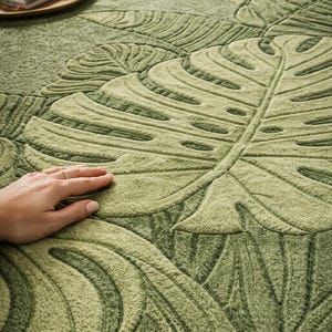 Hand tufted green leaf area rug in modern American living room
Botanical wool rug with raised leaf texture close-up detail
Modern green area rug styled with sofa and coffee table