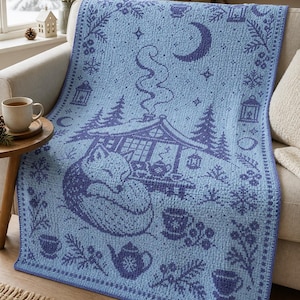 May include: A light blue and dark blue crocheted blanket featuring a repeating pattern of a sleeping fox, a cabin with smoke rising from the chimney, a crescent moon, stars, lanterns, pine trees, teapots, and teacups with floral accents.