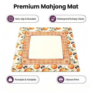 May include: A rectangular mahjong mat with a cream-colored center and an orange and olive branch border. The mat has the text "Premium Mahjong Mat" at the top and icons indicating it is non-slip, waterproof, portable, and has a vibrant print.