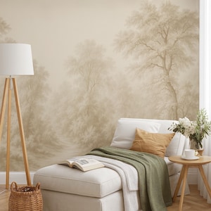 May include: A beige wallpaper mural featuring a soft-focus forest landscape with trees and foliage. The room includes a white chaise lounge with a green throw blanket, a brown pillow, an open book, a floor lamp, and a small wooden side table.
