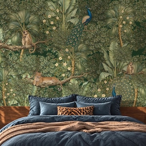 May include: A bed with a dark blue duvet and a leopard print pillow, set against a wall mural featuring a dense jungle scene with monkeys, a leopard resting on a tree branch, and two peacocks amidst lush green foliage and white flowers.