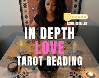 May include: A tarot card reading setup featuring a rectangular table covered with a floral embroidered cloth, multiple lit white candles, small wooden bowls containing crystals and herbs, and a spread of tarot cards with the text IN DEPTH LOVE TAROT READING.