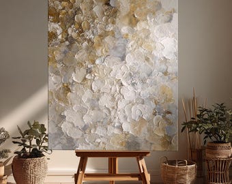May include: A large rectangular canvas painting featuring thick, textured impasto brushstrokes in shades of white, cream, soft gold, and pale gray. The abstract composition creates a layered, organic pattern across the entire surface of the artwork.