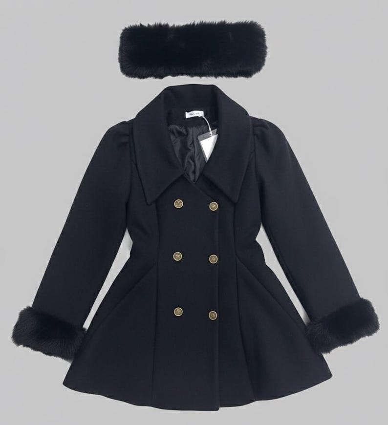 May include: A black double-breasted coat with a wide collar, long sleeves featuring black faux fur cuffs, and six gold-toned buttons. The coat has a flared hem and is paired with a matching black faux fur headband accessory.