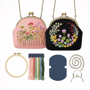 May include: Two kiss-lock frame purses, one pink and one black, featuring floral embroidery. Included are a wooden embroidery hoop, assorted embroidery threads, a dark blue card, a metal chain, and a spare metal kiss-lock frame clasp.