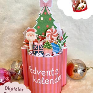 May include: A pink and red striped Advent calendar with a Christmas tree, Santa Claus, and other festive decorations. The calendar has the words "Advents Kalender" on the front and includes a digital download option.
