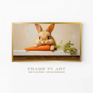 Puede incluir: Una impresión de arte digital enmarcada que presenta un conejo marrón esponjoso sosteniendo una zanahoria naranja brillante. El conejo está posicionado sobre una superficie blanca, con un fondo beige claro. El texto "FRAME TV ART" se muestra en la parte inferior.