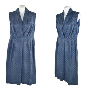 May include: A sleeveless blue dress with a white collar and a small orange floral pattern. The dress has a button-up front and a fitted waist.