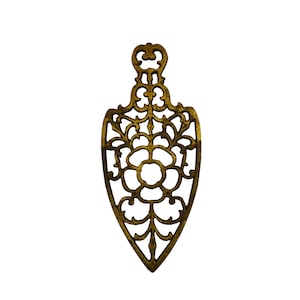 May include: A gold-colored metal pendant with a delicate, intricate design featuring a floral motif. The pendant is shaped like a teardrop and has a loop at the top for attaching a chain.