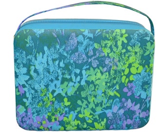 May include: A blue floral patterned zippered travel case with a top handle.