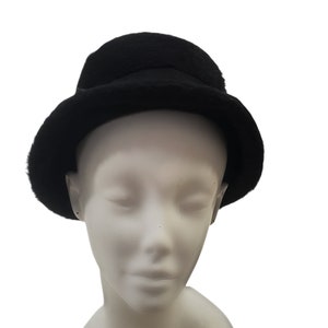 May include: A black felt bucket hat with a wide brim.