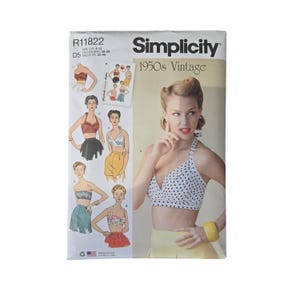 May include: Simplicity 1950s Vintage sewing pattern. The pattern features a woman in a polka dot halter top and yellow skirt. The pattern includes illustrations of different bra and top styles. The pattern is marked with the size US 4-12.