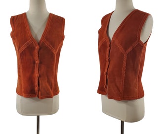 May include: A sleeveless, rust-colored suede vest with a button-up front and decorative stitching.