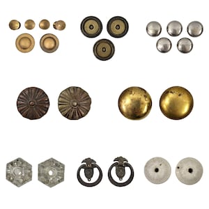 May include: Assortment of vintage metal and glass drawer pulls and knobs in various styles and finishes, including brass, gold, silver, and clear glass.