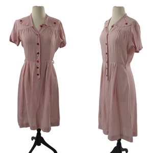 May include: A red and white gingham dress with short sleeves and a button-up front. The dress has a fitted bodice and a full skirt. The dress is on a white background.