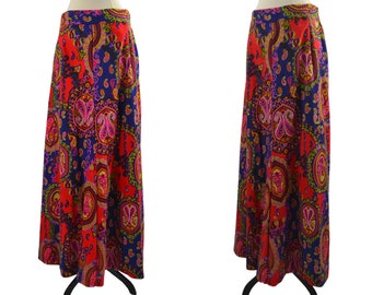 May include: A long, flowing skirt with a paisley print in shades of red, blue, and purple. The skirt has a high waist and a flared silhouette.