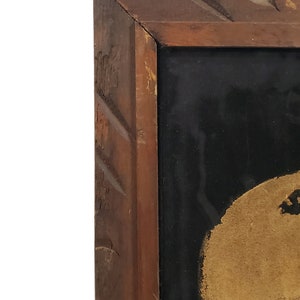 May include: A close-up of a painting in a wooden frame. The painting is of a person's face, with the focus on the eye. The face is painted in shades of brown and black.
