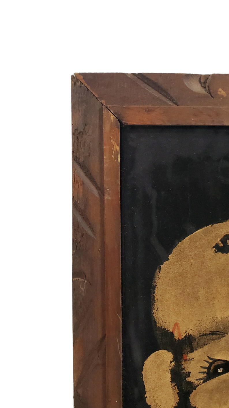 May include: A close-up of a painting in a wooden frame. The painting is of a person's face, with the focus on the eye. The face is painted in shades of brown and black.