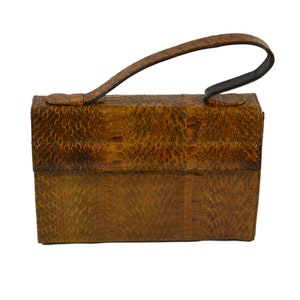 May include: A brown leather handbag with a snakeskin pattern and a top handle.