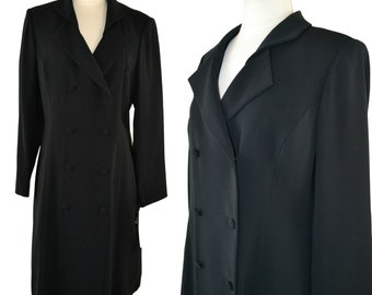 May include: A black double-breasted dress with a long sleeve and a v-neck collar.