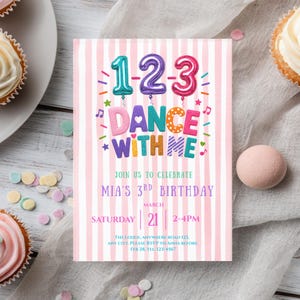 May include: A pink and white striped invitation with the text "1-2-3 DANCE WITH ME" in colorful letters. The invitation is for Mia's 3rd birthday, with the date March 21st, 2-4 PM. Cupcakes and confetti are in the background.