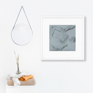 May include: A framed black and white drawing of several hands in various poses. The hands are drawn on a light blue background.