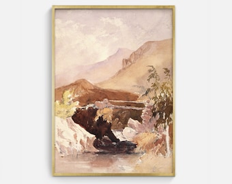 May include: Watercolor landscape art print featuring a mountain range, a river, and a bridge. The artwork is framed in a gold-colored frame. The color palette includes shades of brown, beige, and light purple.