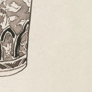 May include: Close-up of a brown and black ceramic vase with a floral design. The vase has a rounded bottom and a wide mouth.