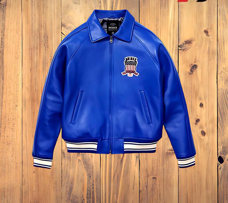 May include: A vibrant blue leather jacket with a white and black striped trim on the cuffs and hem. The jacket features a front zipper and a patch on the chest with a crest design. The jacket has a classic bomber style.