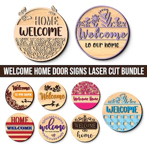 May include: A collection of laser-cut wooden welcome signs. The signs are round with various designs, including butterflies, floral patterns, and the words "Welcome" and "Home." The signs are in various colors, including natural wood, purple, pink, and blue.