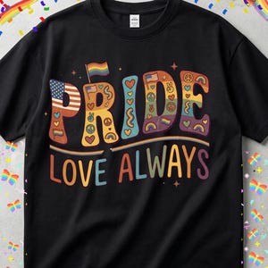 May include: Black t-shirt with the words "PRIDE LOVE ALWAYS" in colorful, retro-style lettering. The word "PRIDE" incorporates rainbow flags, peace signs, and hearts. The shirt has a crew neck and short sleeves.