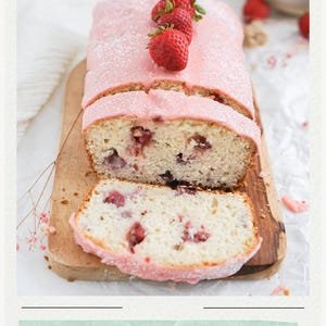 May include: A loaf of strawberry bread topped with pink icing and three fresh strawberries, featuring a sliced piece in front. The bread has visible fruit chunks throughout. The text RECIPE and MUST TRY Strawberry Bread are visible.