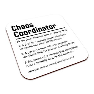 May include: A white square coaster with a brown border displays the words "Chaos Coordinator" in bold black font. The definition of the term is listed below the title, in black text. The coaster is on a white background.