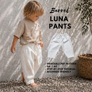 May include: A young child in a beige top and white trousers stands near a plant in a woven basket. The image includes the text "Barrel LUNA PANTS" and details about a printable PDF pattern.
